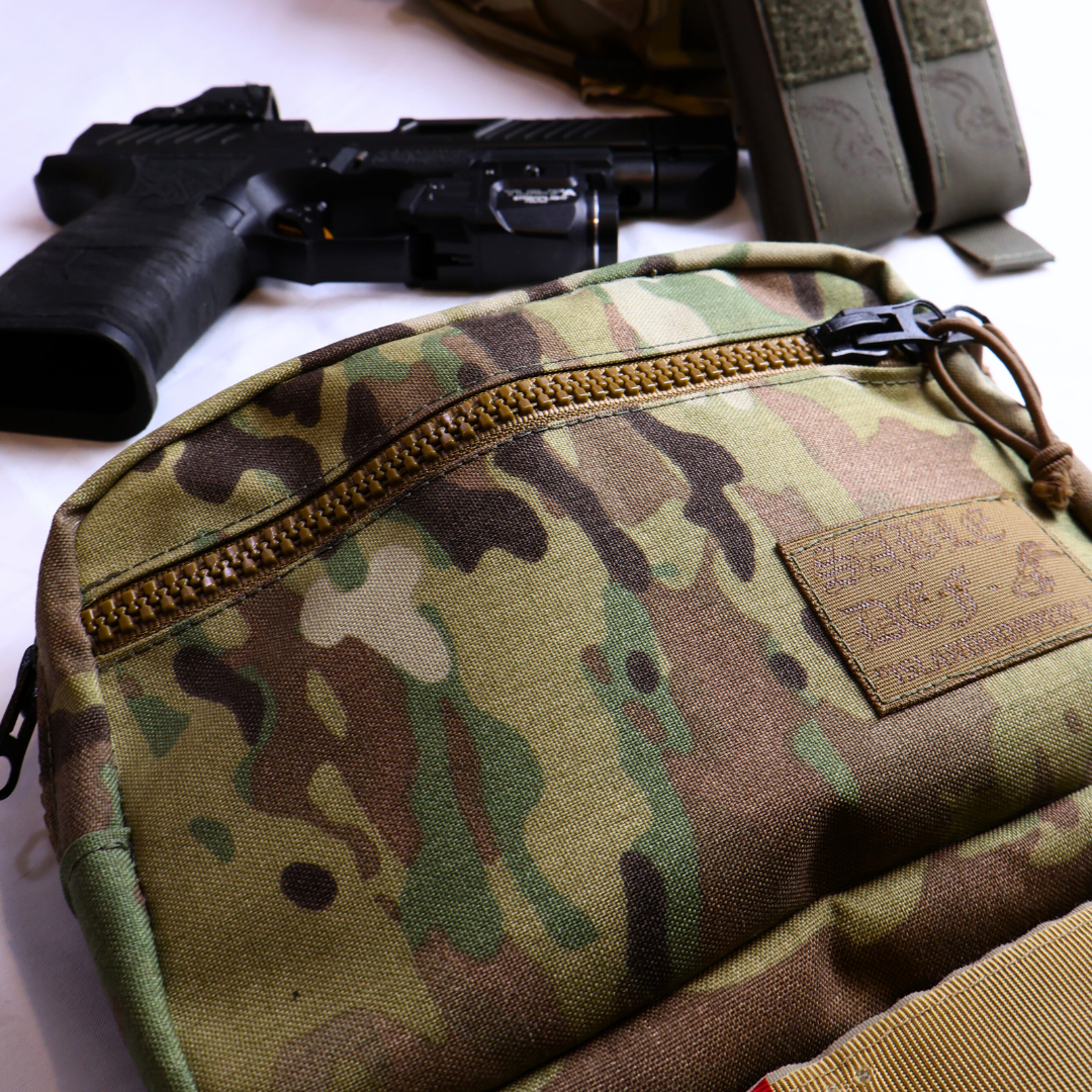 Camouflage pouch with a patch and a gun on a white background
